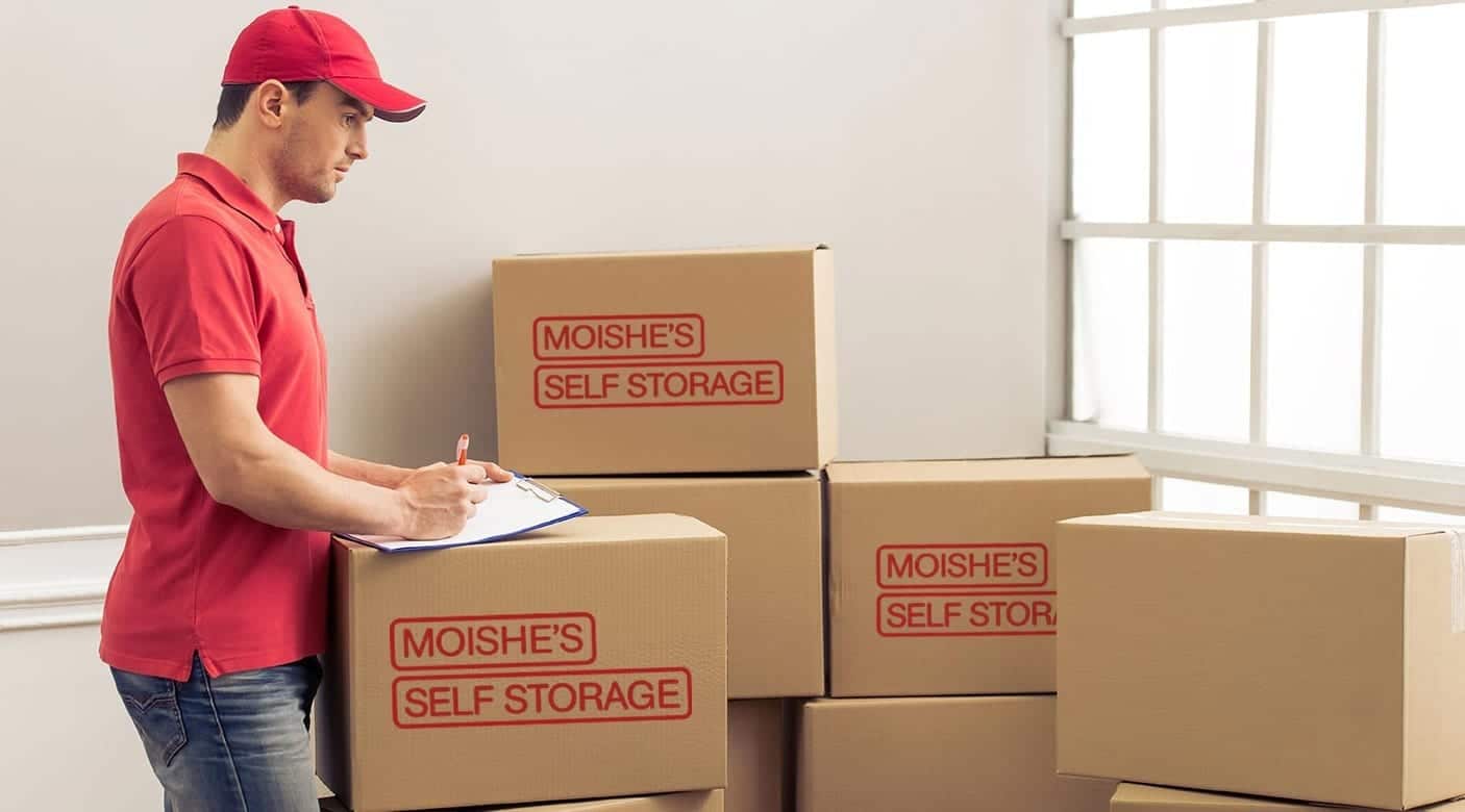 Moishe's Self Storage worker creating an inventory list before transporting items to a storage unit