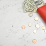 dollar bills in a wallet and coins on a counter