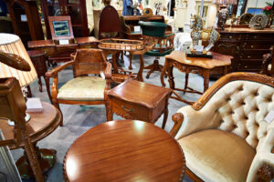 Various antique wooden furniture in a room.