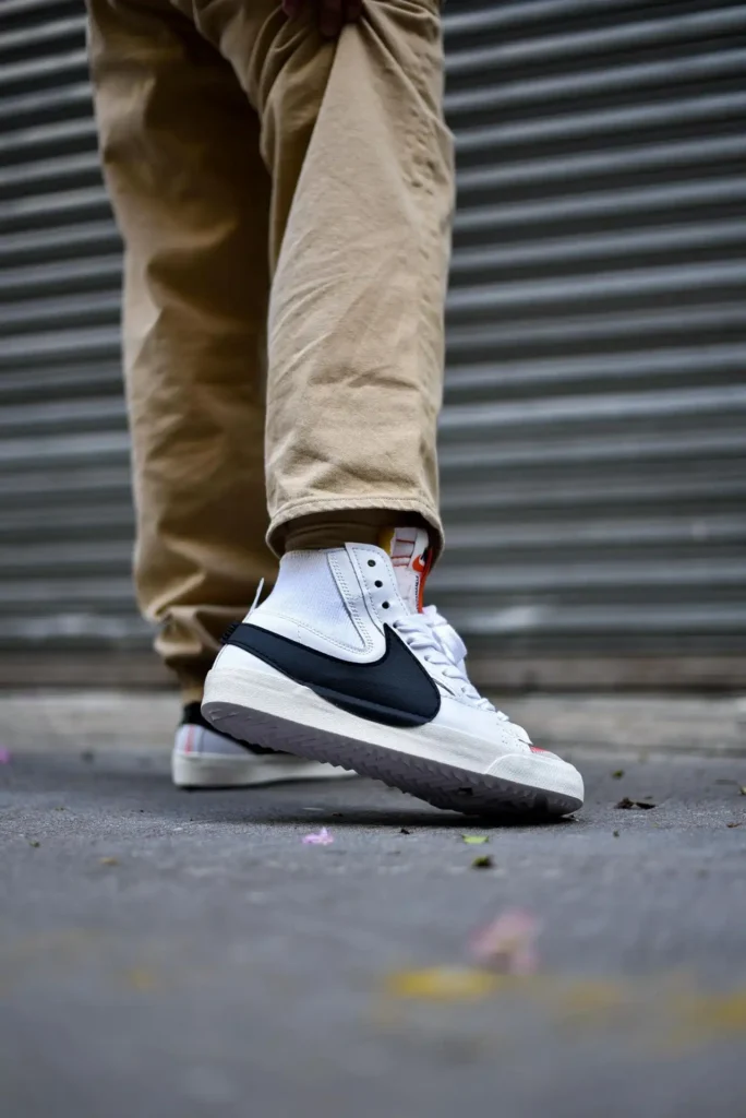 Person wearing sneakers walking toward a self-storage unit.